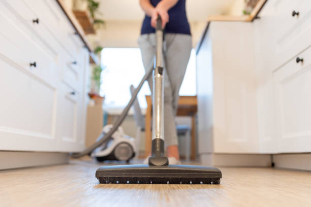 Lady sweeping flooring | Bob's Carpet and Flooring