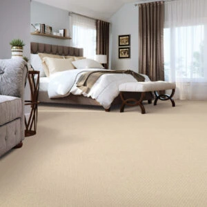 Cozy bedroom with beige carpet floors