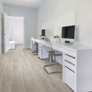 Home office with light laminate flooring