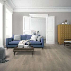 New laminate flooring in a seating area with a blue sofa