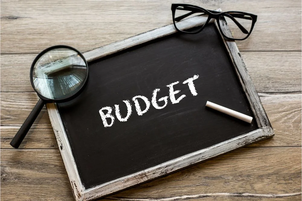Budget written on a framed black chalkboard